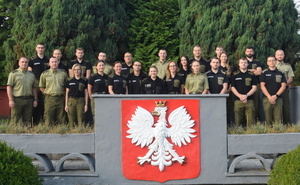 Zdjęcie grupowe funkcjonariuszy SG na tle zieleni Zdjęcie grupowe funkcjonariuszy SG na tle zieleni