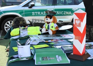 Stoisko promocyjne SG w tle pojazd służbowy SG