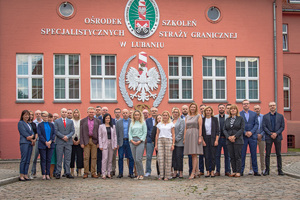 Zdjęcie grupowe funkcjonariuszy i prowadzących przed budynkiem Ośrodka